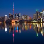 buildings near body of water at night