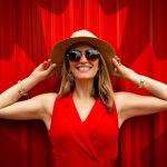 woman in red sleeveless dress with canada flag printed background