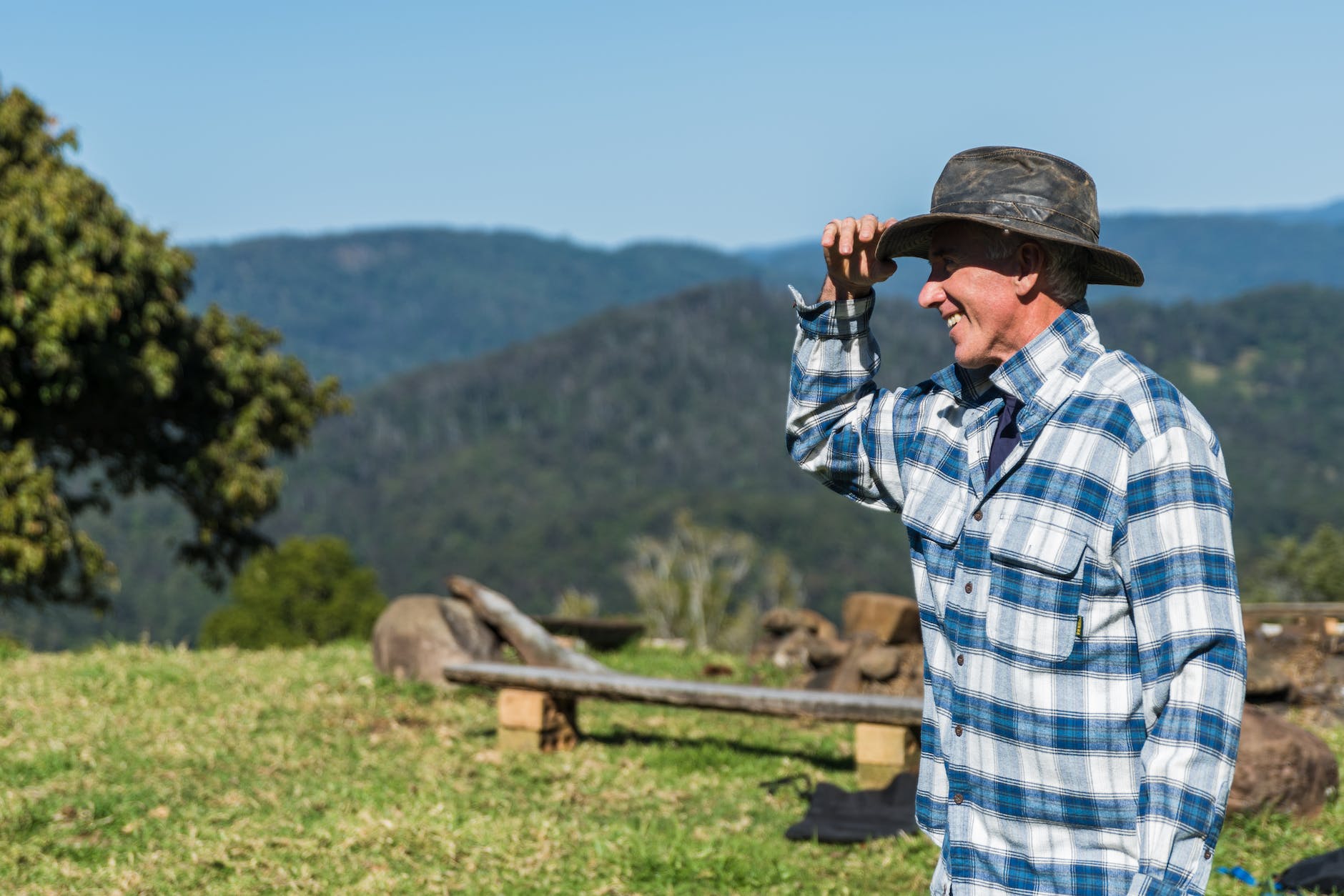 man wearing blue and white checked sport shirt and black hat