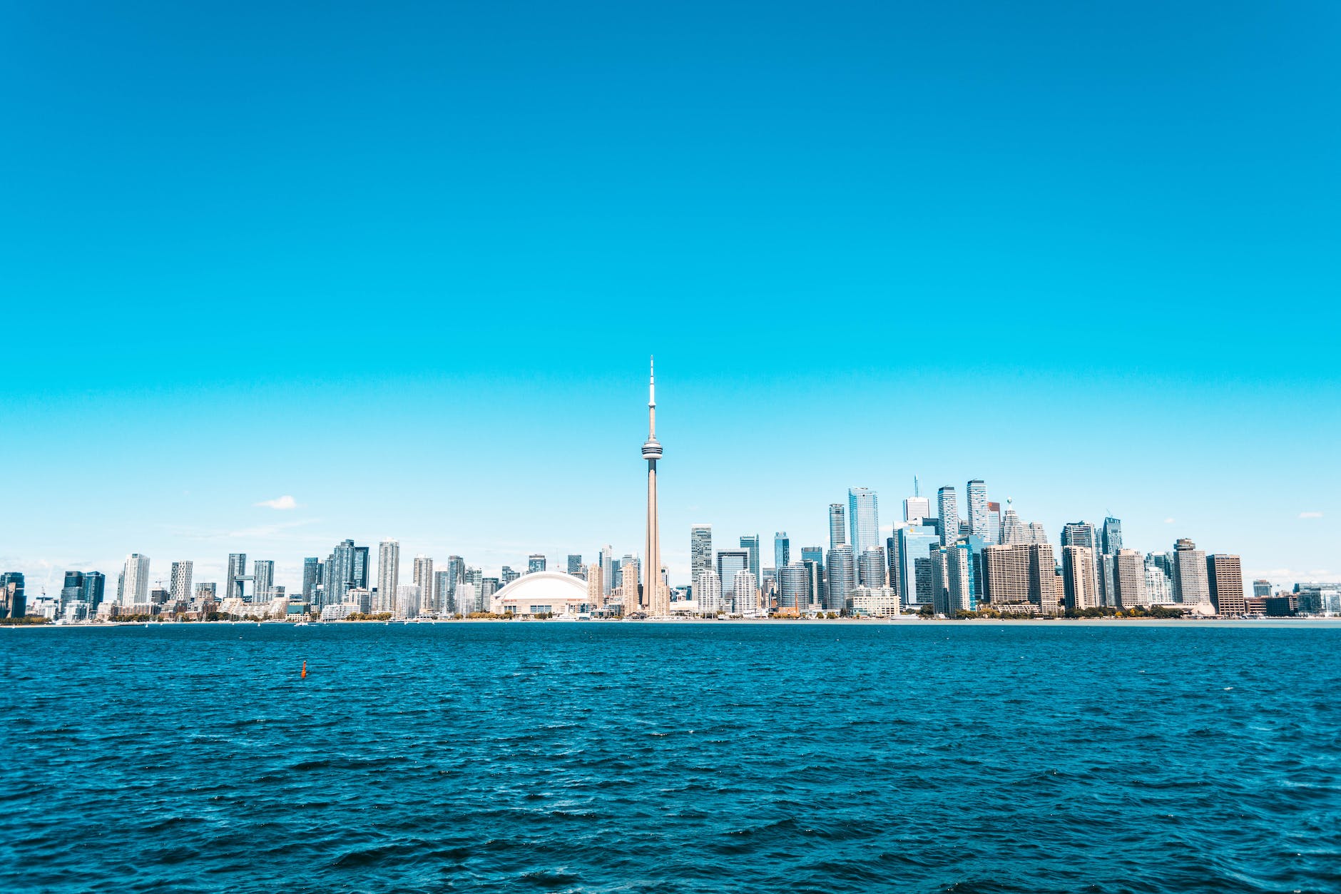 city buildings near sea under blue sky