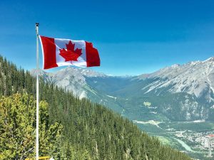 canada flag with mountain range view